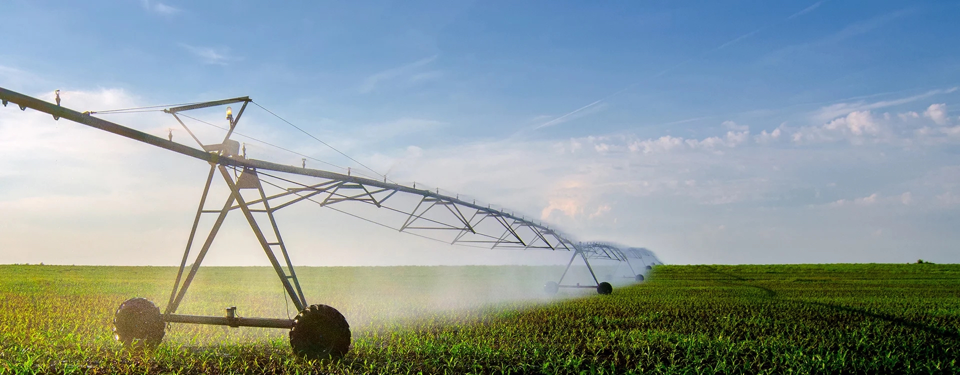Center-pivot irrigation system spanning a green field